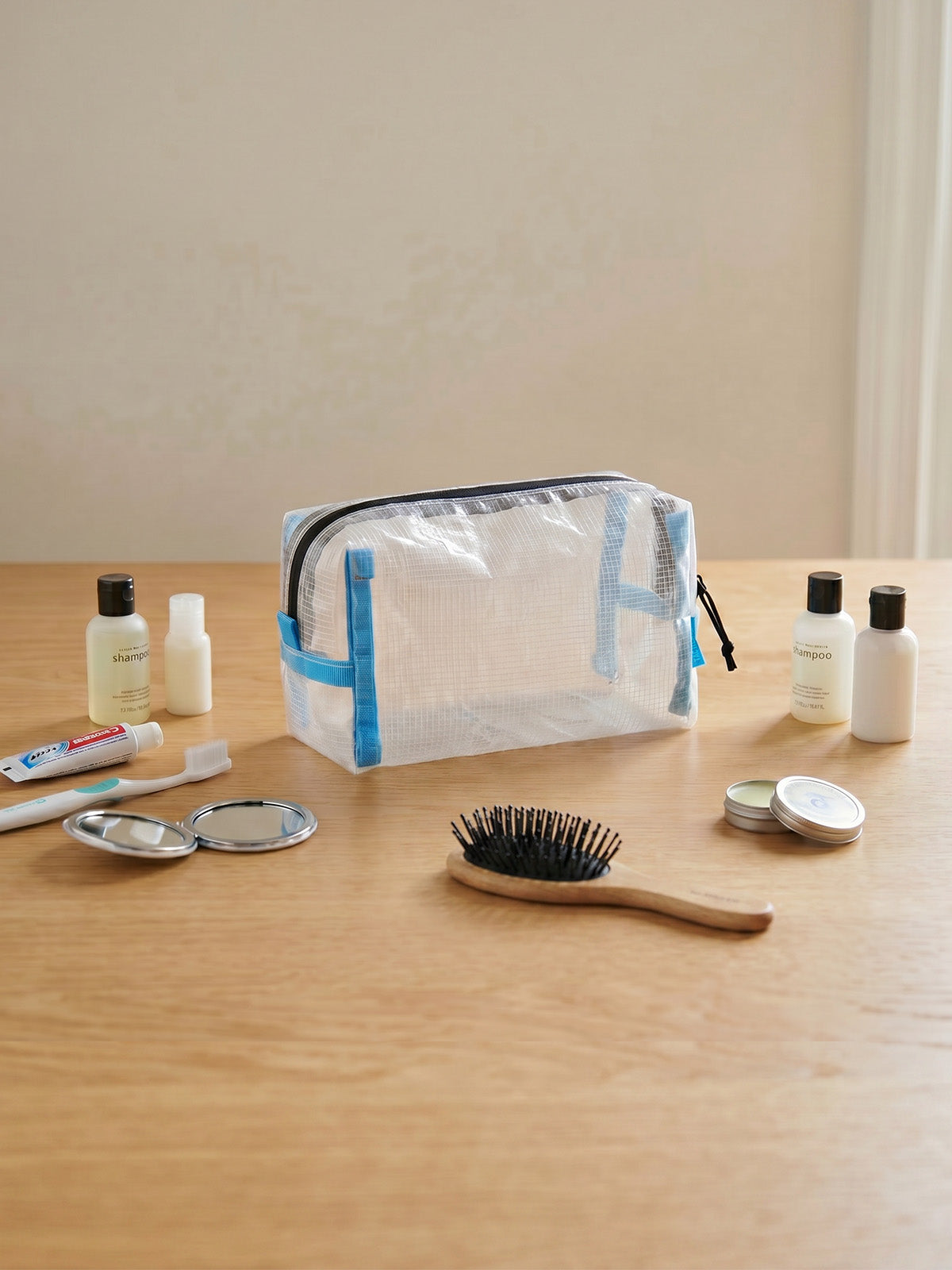 HS4 clear electronics organizer pouch displayed with grooming items