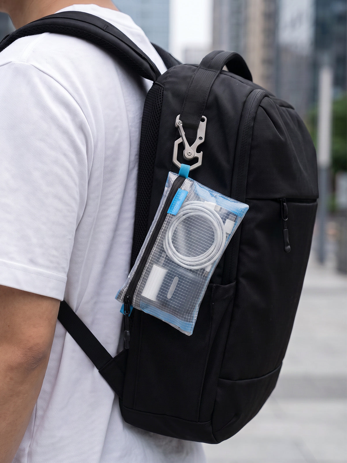 HS5 clear slim organizer pouch attached to the outside of a backpack
