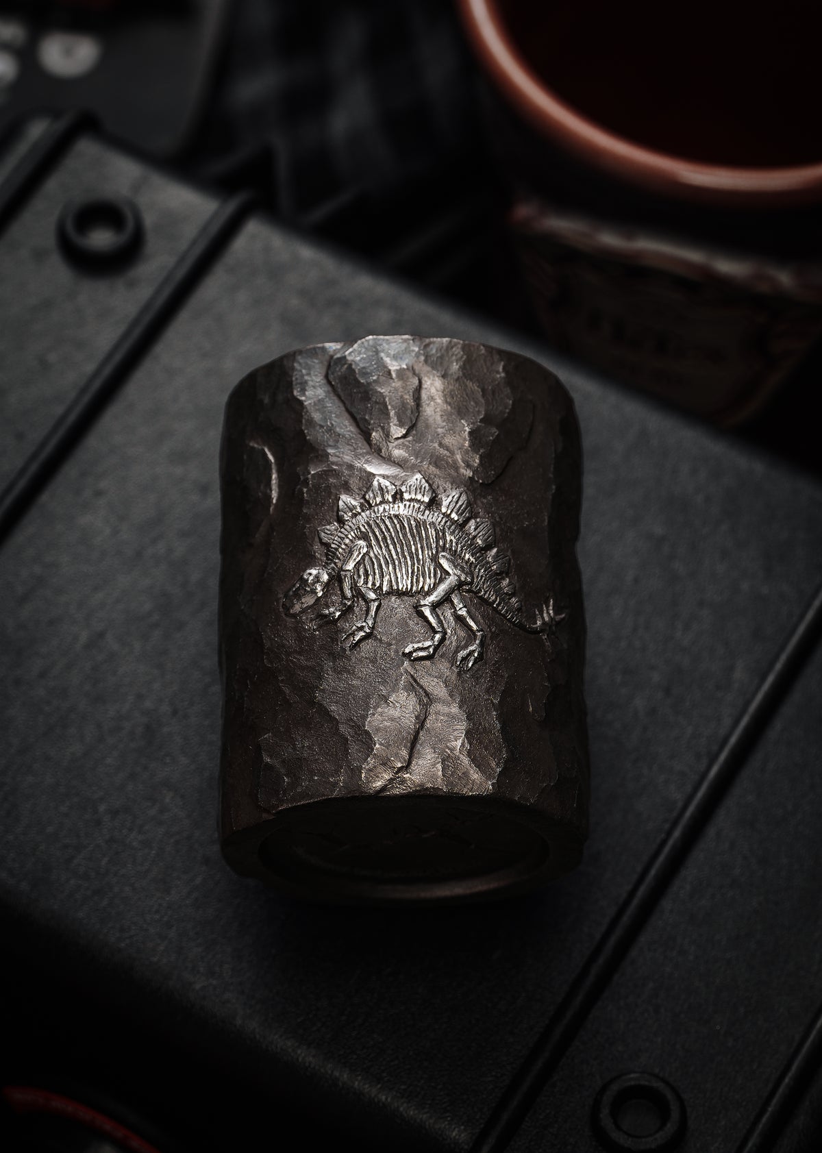 TacticalGeek_x_Sunizumi_One-Off_Hand-Carved_Titanium_Sake_Cup_Stone-Texture_Stegosaurus-1