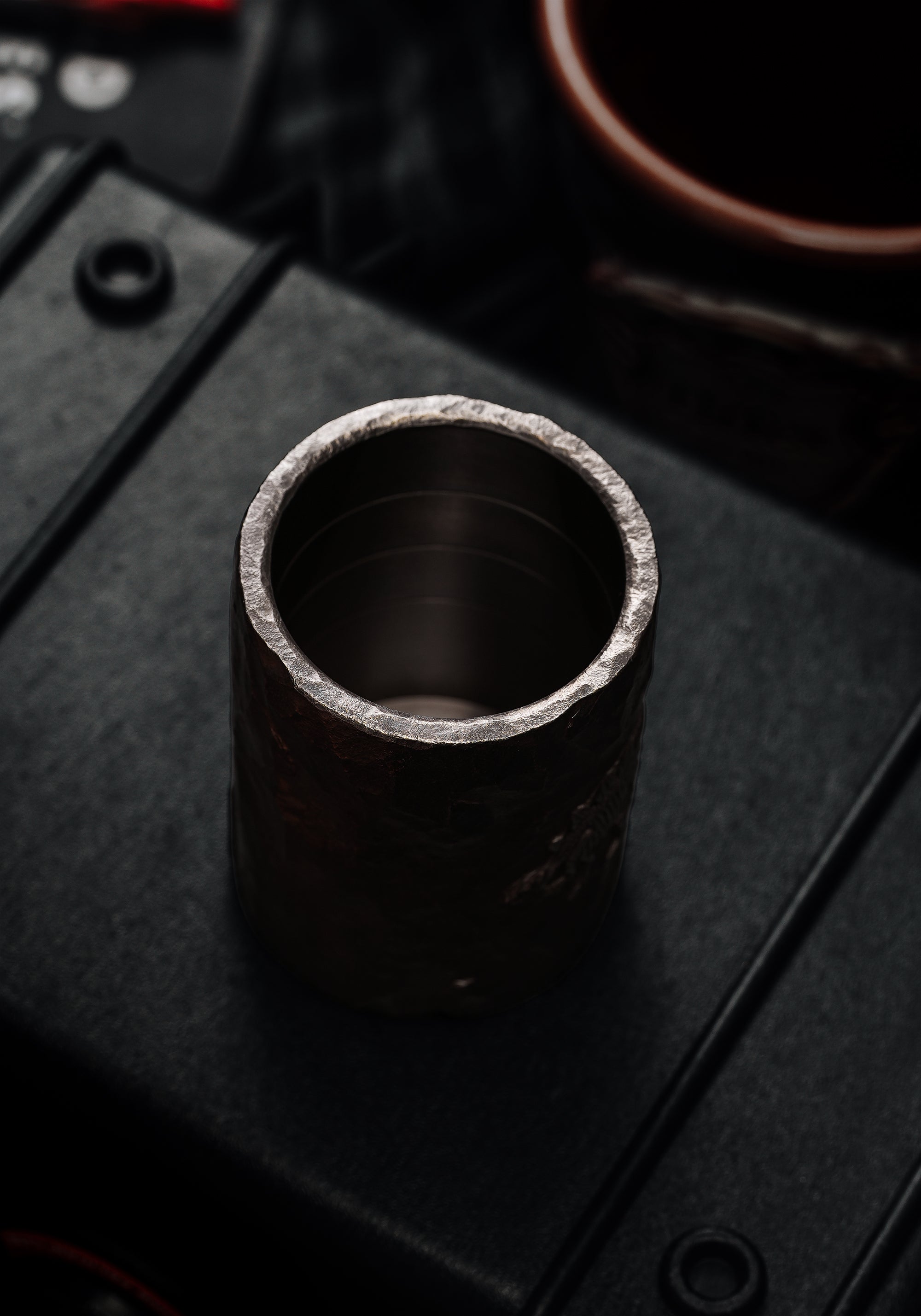 TacticalGeek_x_Sunizumi_One-Off_Hand-Carved_Titanium_Sake_Cup_Stone-Texture_Stegosaurus-2