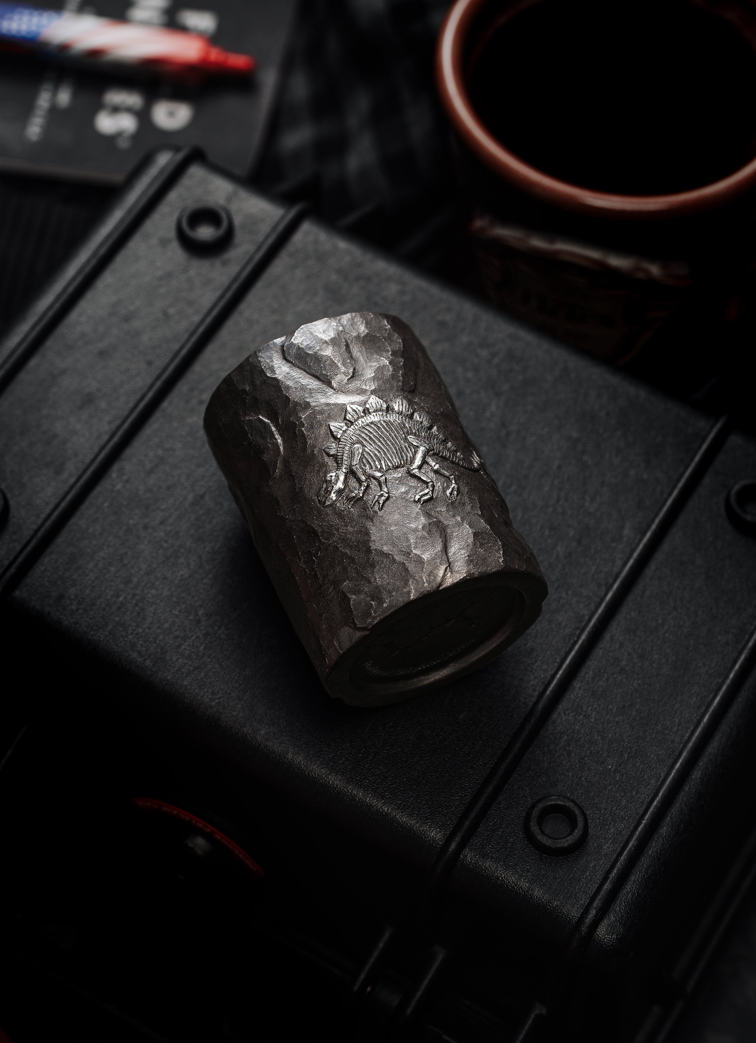 TacticalGeek_x_Sunizumi_One-Off_Hand-Carved_Titanium_Sake_Cup_Stone-Texture_Stegosaurus-4
