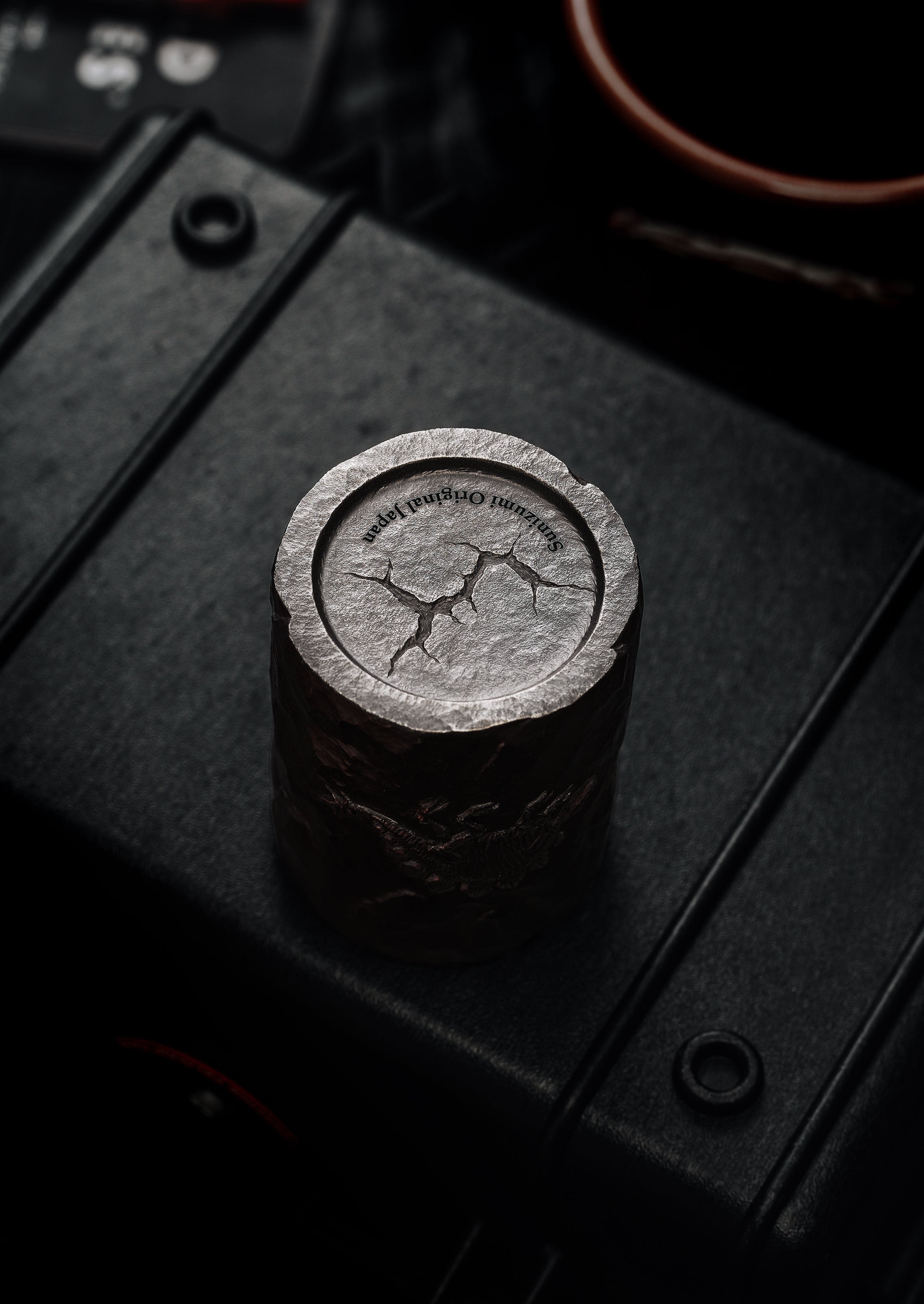 TacticalGeek_x_Sunizumi_One-Off_Hand-Carved_Titanium_Sake_Cup_Stone-Texture_Stegosaurus-3